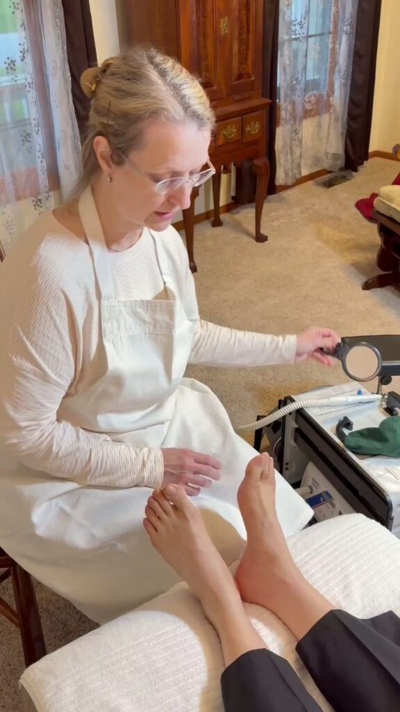 Nurse performing a routine in-home foot care visit